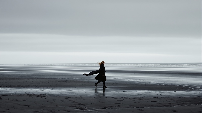 A long coat on black sand., made with Flux 1.1 Ultra